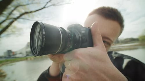 Photographer Films Outdoors With a Digital SLR Camera