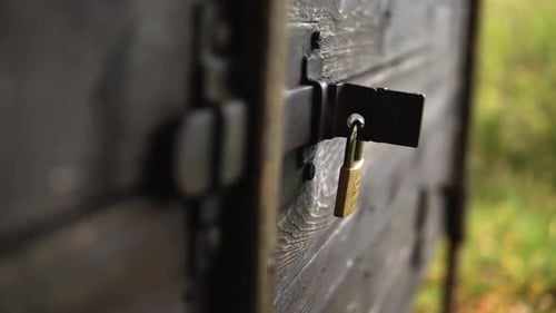 Wooden cabin locked with a lock that was just closed.
