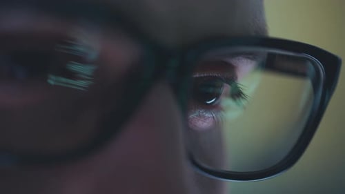 Eyes Reflecting Screen in Glasses Close Up