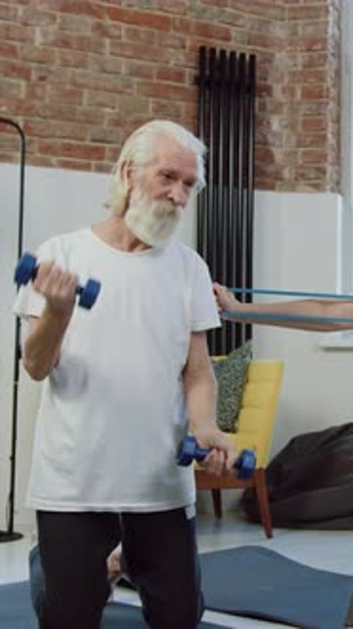 Senior Man Lifting Weights in Home Gym
