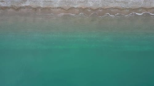 A drone flies over the transparent Adriatic Sea in Croatia. Beautiful azure water and coastline.