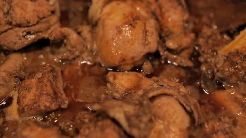 Close-Up of Savory Chicken Simmering in Sauce