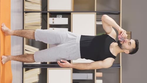 Man Drinking Water After Exercising Indoors