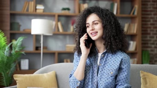 Smiling Woman Talking on Phone in Home
