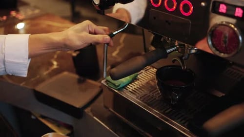 4K Barista steaming fresh milk in frothing pitcher to making froth milk.