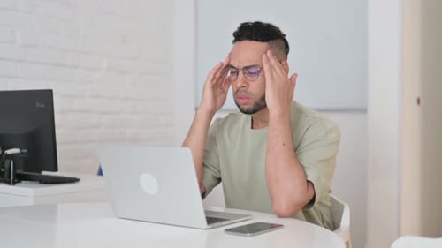 Man With Headache Working at Computer