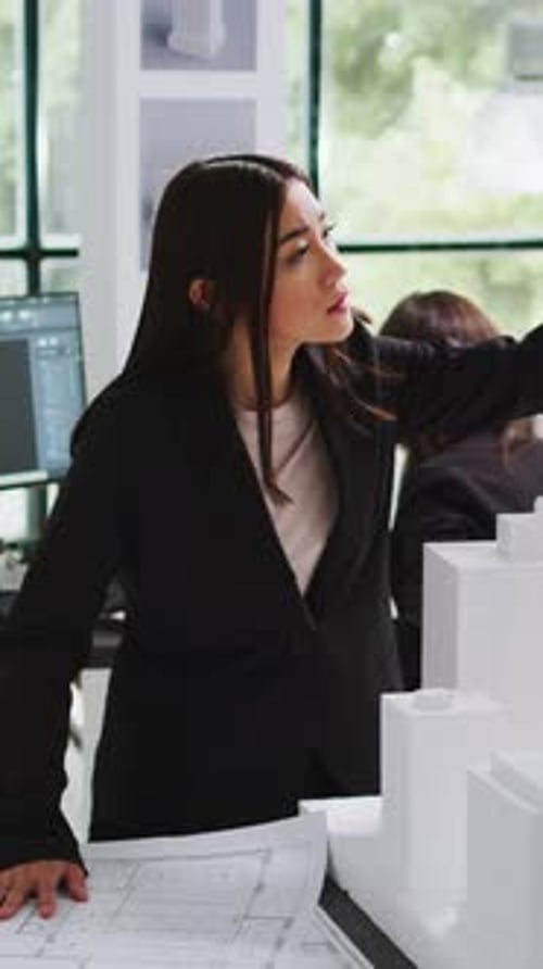 Vertical Video Architecture Office Employee Looking at Building Model