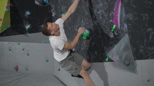 Man Indoor Rock Climbing at Climbing Gym