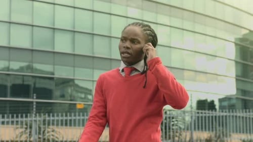 Professional man talking on phone outside office building