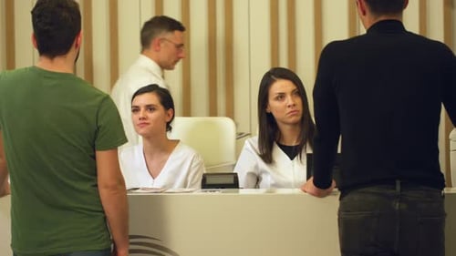 Medical Reception Desk with Staff and Visitors
