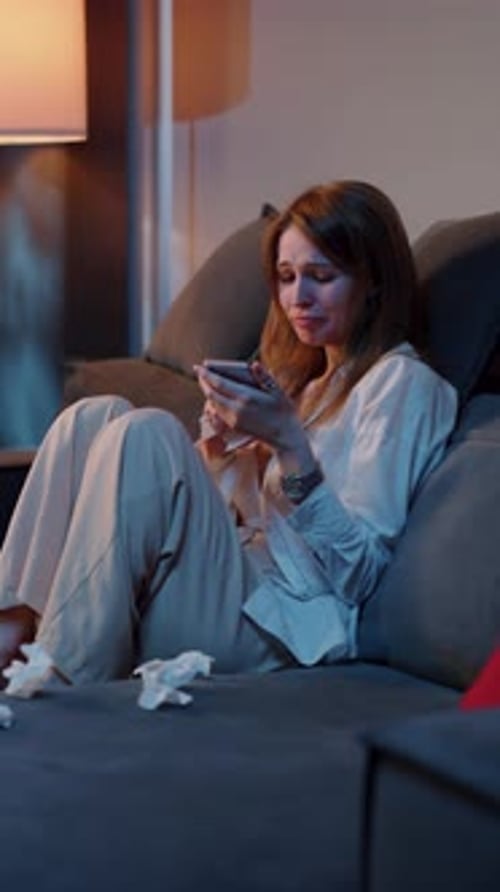Woman Crying While Reading Message on Phone