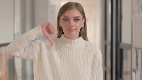 Woman Gives Thumbs Down in Interior Setting
