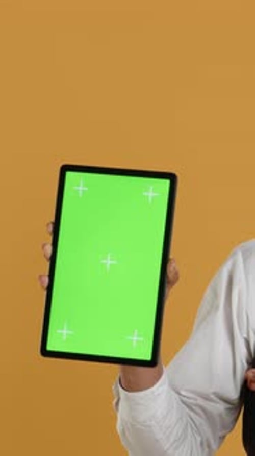 Vertical Video Restaurant Waiter Presenting a Green Screen Layout on Tablet