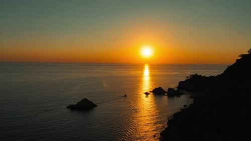 Cliffs and sea at sunset, boat