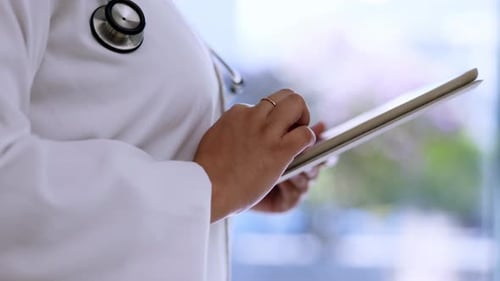 Doctor Using Tablet in Hospital Setting