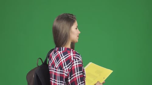 Smiling Woman in Plaid Shirt Holding Folders