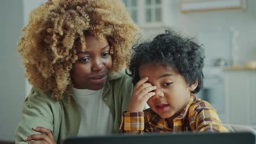 Curious Little Kid Watching Video on Laptop with Mom at Home