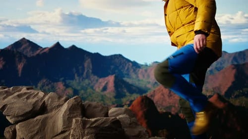 Adventure Seeker Gazes at the Valley and Mountain Peaks Ahead