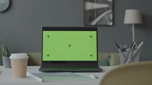 Laptop with Green Screen at Office Desk