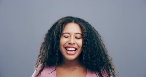 Cheerful Woman Smiling and Winking in Studio