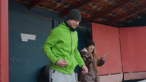 Young Adults in Cold Weather Standing Near Bench