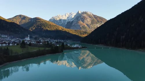 Amazing mountains reflected in the lake with sunset. Aeria view.