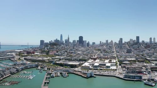 Wide aerial descending shot of Fisherman's Wharf in San Francisco on a clear day. 4K