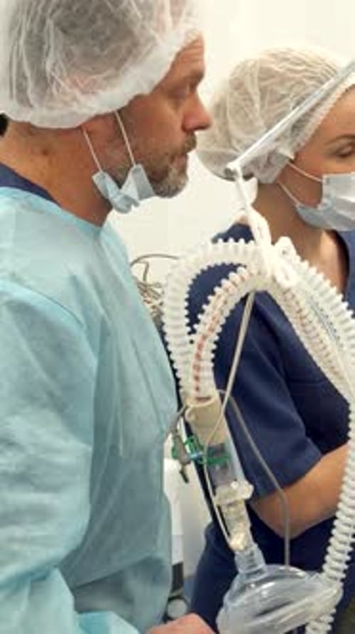 Surgical Nurse Points Her Finger on the Monitor
