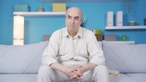 An elderly man is worried, stressed and thinking about a problem.