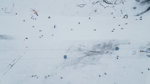 Snowcovered Skiing Area with Numerous Skiers and Snowboarders Enjoying the Winter Sports at a