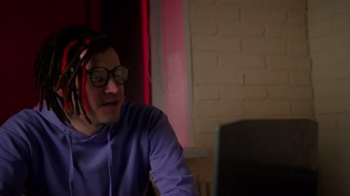 Young Adult Talking Near Computer Indoors