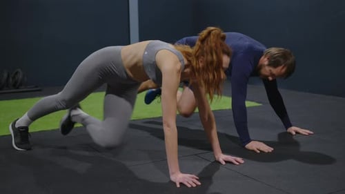 Couple Fitness and Gym Workout of Training Friends Together for a Core Strength Exercise for Abs