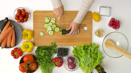 Woman Prepares Salad Ingredients in Home Kitchen