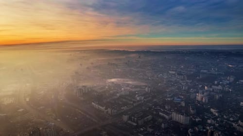 Aerial drone timelapse view of Chisinau at sunrise, Moldova. View of the city with fog in the air, m