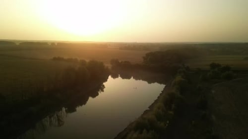 Swans on the lake at sunset. Sunset on the lake in the fields
