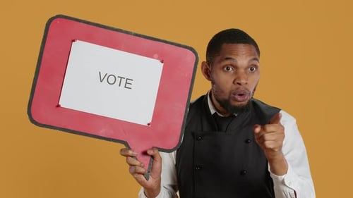Man holding up speech bubble urging people to vote