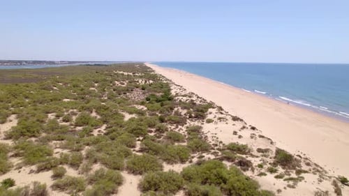 Flight over the beach line and sandbanks. Coast line and beach aerial view in ascent. Andalusia. Spa