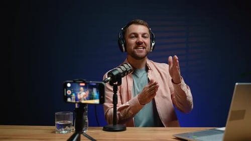 Man at Desk Talking into Microphone