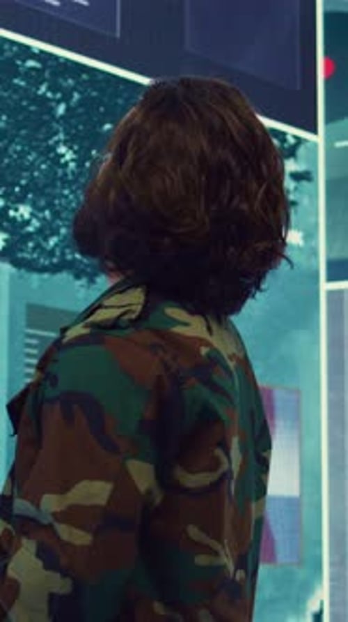 Vertical Video Army Major Monitoring Data on a Big Screen in Military Command Center