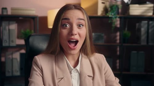 Surprised Young Woman Talking in Professional Home Office