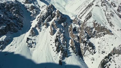 Idyllic extreme alpine terrain, untouched mountainous summit, aerial