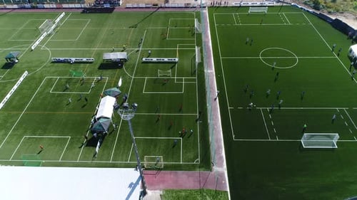 Aerial footage Children Playing football in soceer stadium