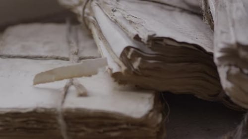 Stacks of Aged Documents Tied with String