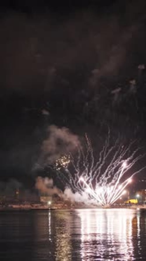 Fireworks with colorful lights over sea