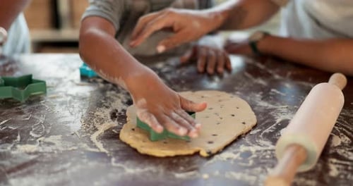 Child and Adult Making Cookies Together at Home