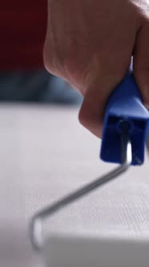 Paint Roller Applies White Paint in Bright Home