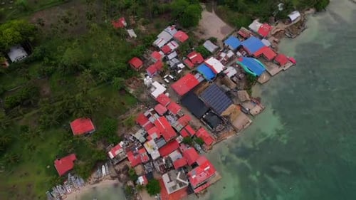 Sustainable rustic village on the seashore of a tropical island. Aerial view