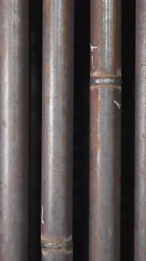 Metal Pipes Row with Welding Seams in Factory Storehouse