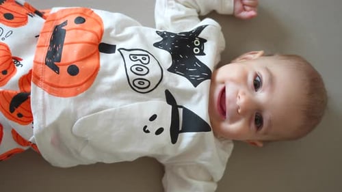 Cute Baby Wearing Halloween Outfit Lying Down Smiling