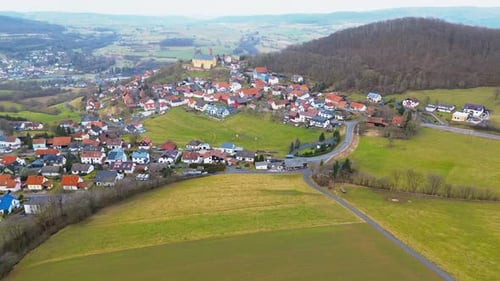 Serene Aerial View of a Small Town with Castle in the Countryside